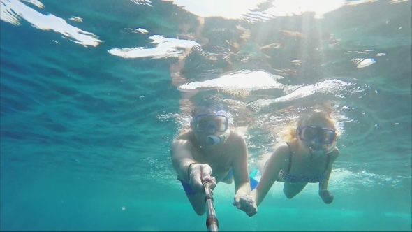 Couple Swimmers Doing Selfie Using Sticks Under Water alt