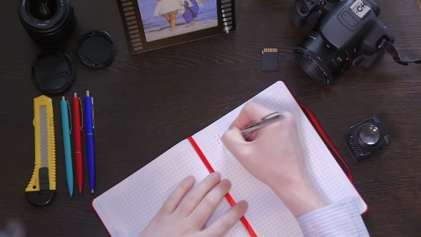 A Man Writes Smile a Pen In Notebook