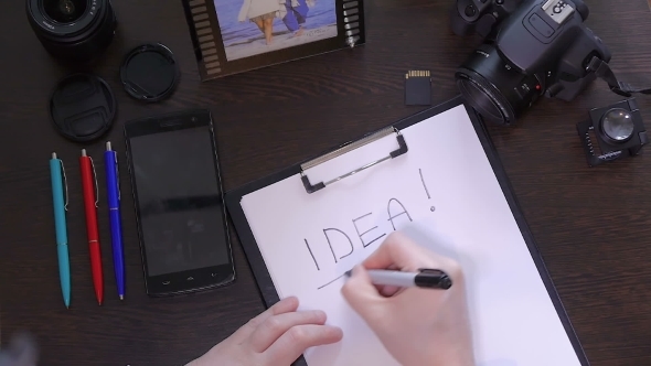 A Man Writes a Pen On Paper Word Idea