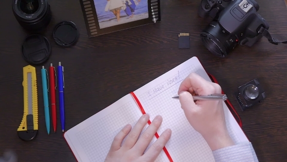 A Man Writes a Pen In Notebook