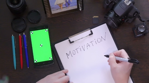 A Man Writes a Pen On Paper Word Motivation