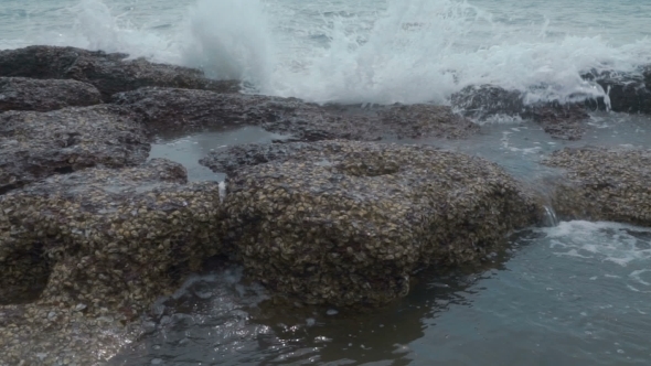 Sea Waves Breaking On Rocks With Splashes