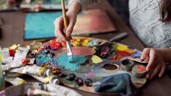 Paintbrush In Woman Hands Mixing Paints On Palette, Stock Footage ...