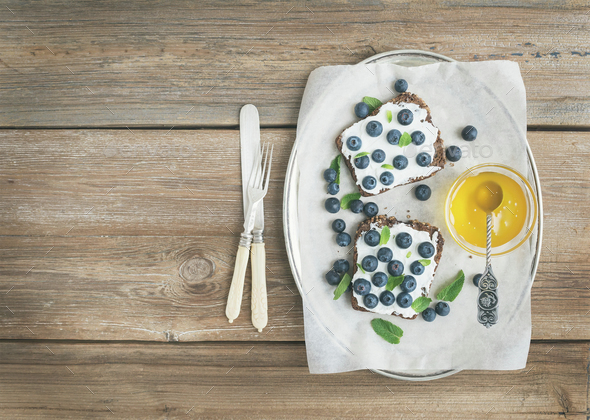 Healthy breakfast set with ricotta, fresh blueberries, honey and - Stock Photo - Images