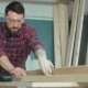 Carpenter In Protective Goggles Sawing Boards In The Workshop - VideoHive Item for Sale