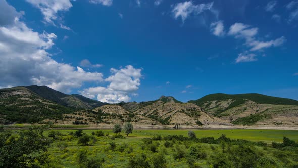 Mountain with Clouds and Beautiful Field with Animals alt