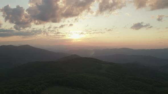 Aerial parallax during sunrise above appalachian mountains alt