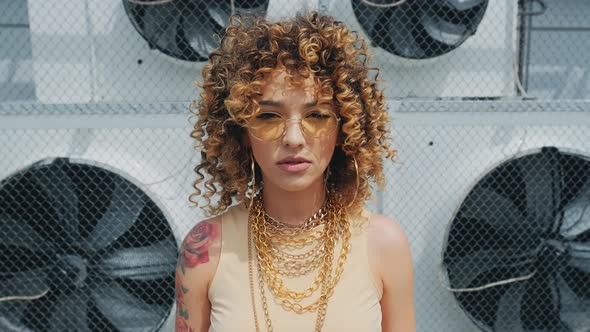 Vogue Style Portrait of Beautiful Afro Curly Woman Is Looking To the Camera Seriously alt