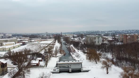 Aerial Kharkiv, speedup fly above frozen river dam