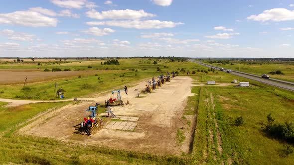 Aerial view of the row of oil derricks in summer alt
