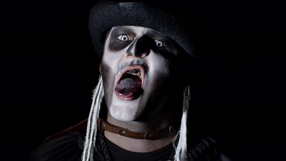 Sinister Man with Skeleton Makeup Appearing From Darkness When Light Falls on Him, Making Faces alt