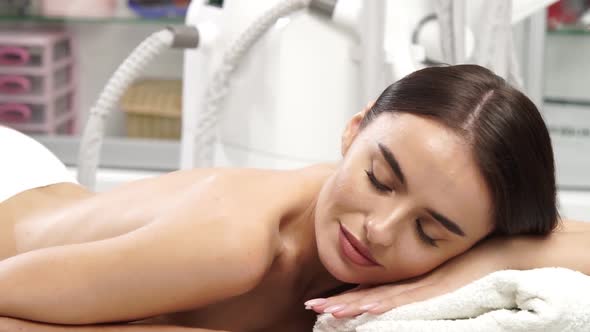 Beautiful Woman in White Panties Lying on Massage Table alt