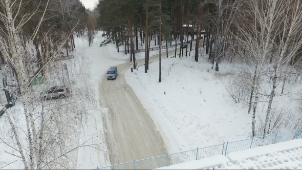 Flying Over The Car In The Woods. Car Under The Bridge. Winter Forest Road