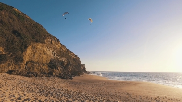 Paragliders Fly Over The Ocean Beach