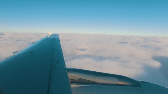 Airplane Is Flying Above The Clouds