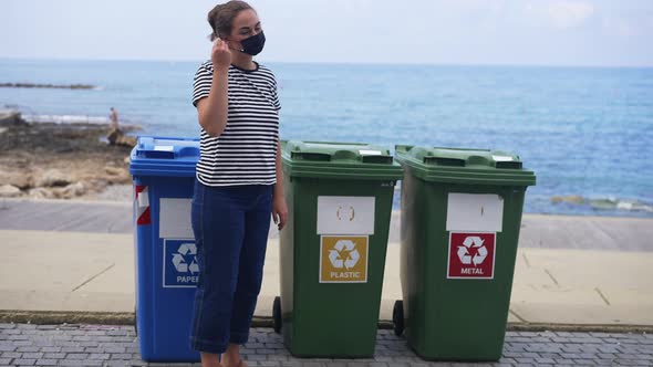 Confident Caucasian Young Woman Taking Off Coronavirus Face Mask Throwing Garbage in Plastic Waste alt