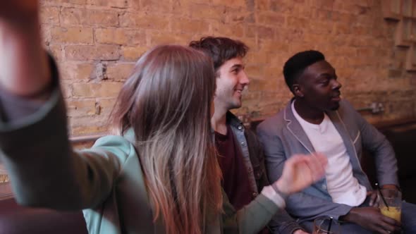 Happy friends having fun at bar and taking a selfie alt