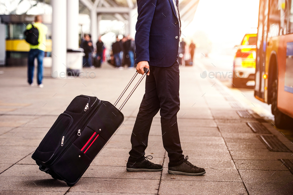 Unrecognizable businessman with luggage at the airport, entering - Stock Photo - Images
