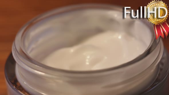 Feminine Hand Taking Skin Care Cream From the Jar