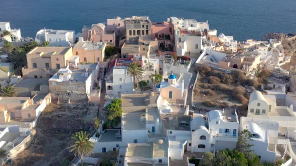 Aerial shot of famous Oia village in Santorini at sunrise in Greece.
