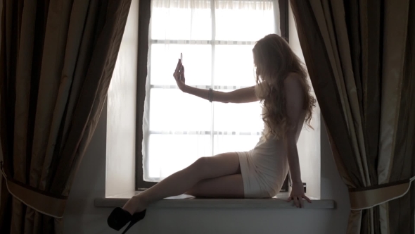 Blonde Takes Pictures Of Herself On The Phone alt