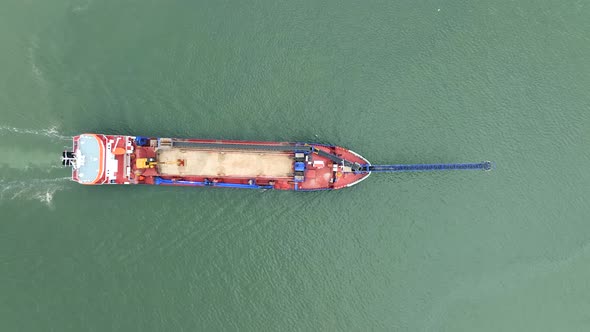 Bird's Eye View of a Self Unloading Barge Carrying Cargo At Sea alt