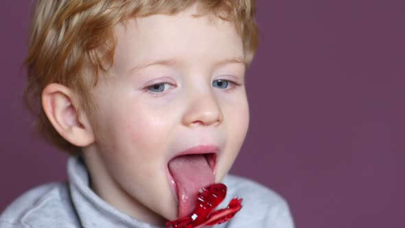 Boy Licking Red Lollipop