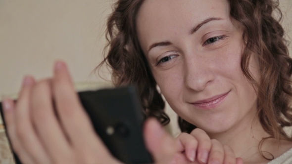 Woman Using Phone At Home alt