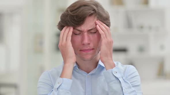 Portrait of Tired Young Businessman Having Headache alt