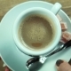 The Female Puts a Cup Of Coffee On a Table - VideoHive Item for Sale