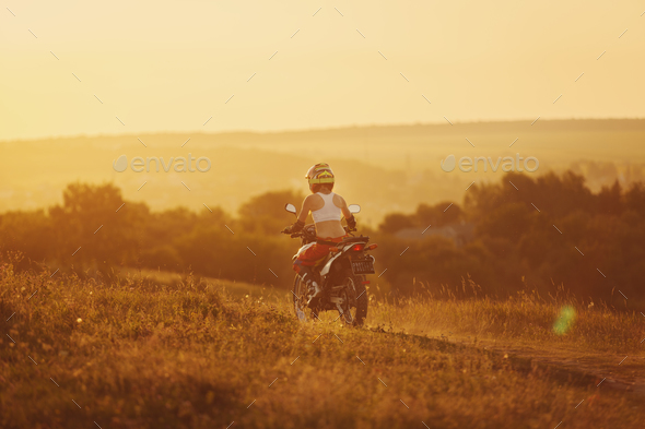 Woman biker in sunset, female motorcycle.