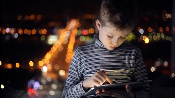Boy Playing on a Tablet alt