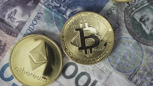 Physical Bitcoin, Litecoin and Ethereum Gold Coins Lying on a Polish Zloty or PLN Banknotes