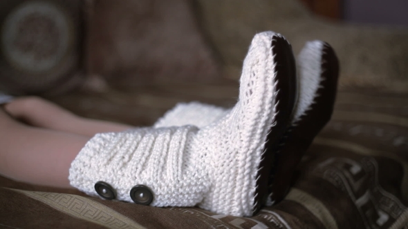 Legs Of Woman In White Knit Socks Are Moving To The Music, 