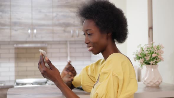 Beautiful African American Woman Uses Mobile Phone Internet Communication with Friends Online Social