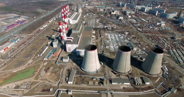 Coal Fired Power Station With Cooling Towers Releasing Steam Into Atmosphere.