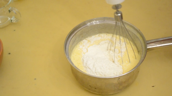 Mixing Flour With a Mixture Of Whipped Eggs And Sugar - Making Egg Sponge