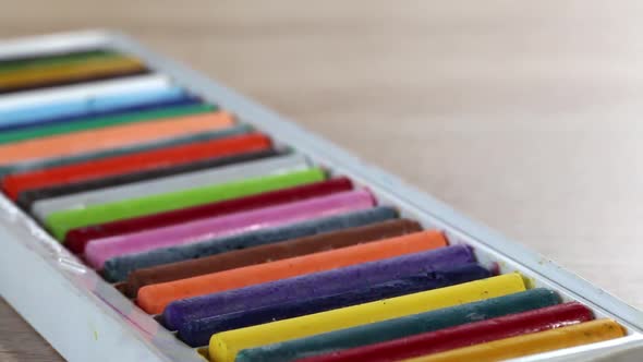 Colored Pastels For Drawing.  In Open Packaging. Slider Camera. Shooting Diagonally. Close Up