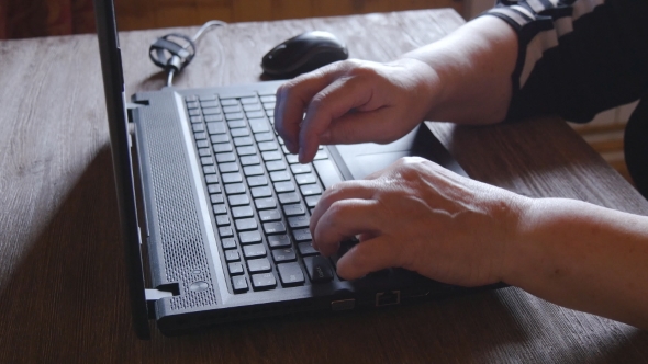 Old Woman Working On Laptop Computer At Home alt