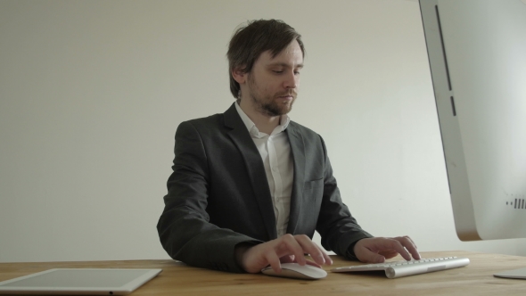 Experienced Businessman Looking At Financial Data With Graphics And Charts While Work On a Laptop alt