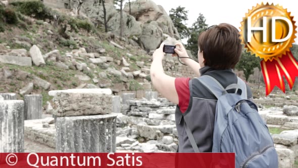 Tourist Photographing Ruins of Ancient Temple