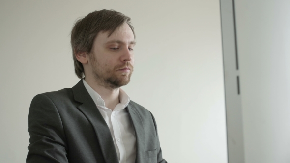 Experienced Businessman Looking At Financial Data With Graphics And Charts While Work On a Laptop