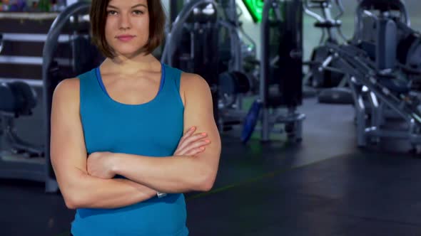Fitness Woman Keeps Arms Crossed on Her Chest alt