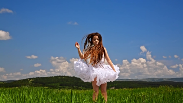 Cute Girl Jumping In Green Meadow
