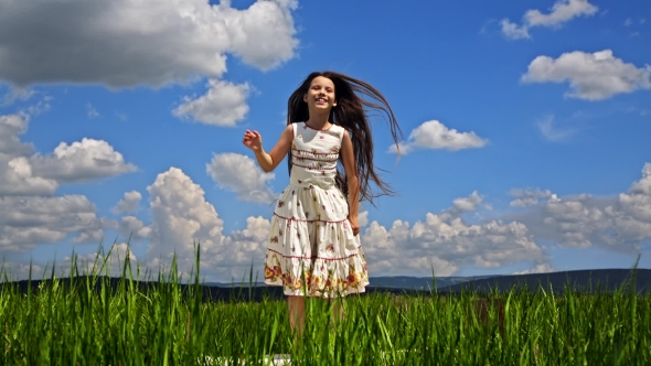 Pretty Girl Jumping In Green Field
