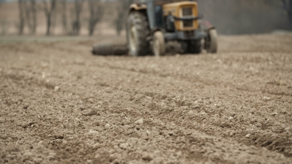 Agricultural Tractor Sowing And Cultivating Field alt