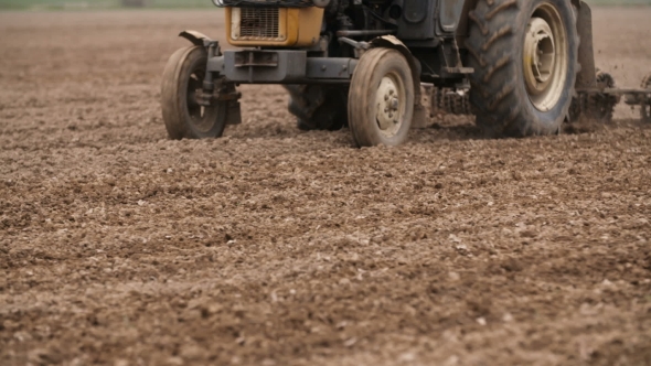 Agricultural Tractor Sowing And Cultivating Field alt