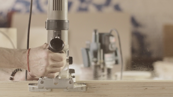 Carpenter Careful Cut Wooden Board By Plunge Router. Treatment ...