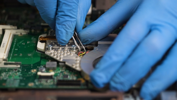 Man Repair Laptop Motherboard With Screwdriver alt