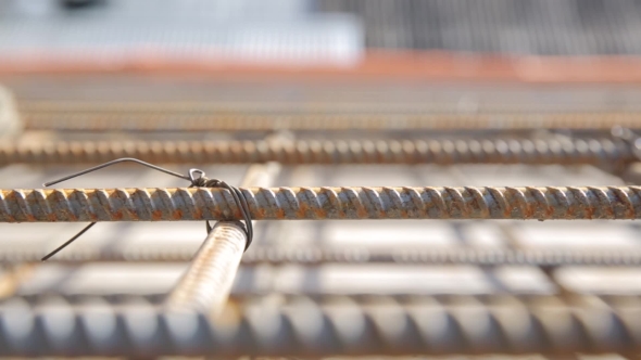 Construction Worker In Old Uniform Tied Armature At Construction Site